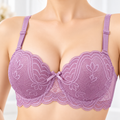 Lavender floral lace padded underwire bra worn by a female model, featuring adjustable straps, scalloped lace edges, and decorative center bow.
