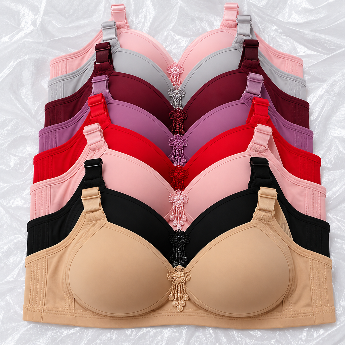 Ladies' lightly padded bra available in eight elegant shades, featuring seamless-look cups, delicate floral embroidery, adjustable straps, and wide supportive side panels.